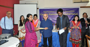 Professor Rehman Sobhan handing over certificate to a participant