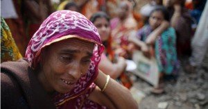 Andrew Biraj/Reuters – A relation of a garment worker, who is still missing after the Rana Plaza building collapse, cries during a protest in front of the site. Hundreds of garment workers and activists gathered in front of the Rana Plaza site seven months after its collapse.